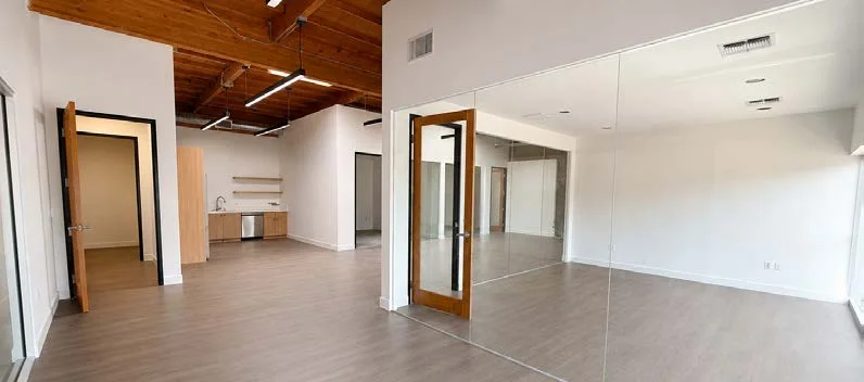 Office interior with warm flooring and exposed timber, Lee brochure Suite 2027